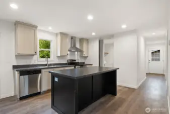 Hallway to the right in this picture leads to two bedrooms, a full bath and a side entry door.