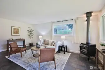 The living room (upon entry) with the kitchen to your back. Cozy propane stove and ceramic tiled floors.