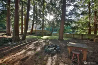 A favorite aspect of this property is the grove of firs and cedars, a mini-forest adjacent to your sunny lot! Fire pit and plenty of space to hang a few hammocks.
