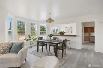 Bright and cheery living space is lined with windows letting sunshine in.