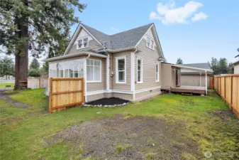 Backside of home, includes new fencing and covered back deck.
