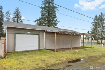 Side view of detached garage showing one of two covered carports.