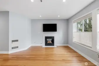 Cozy fireplace with TV mounted above.