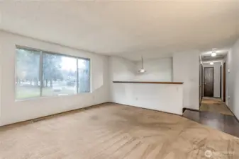 Living room has large bright window overlooking the front of the property