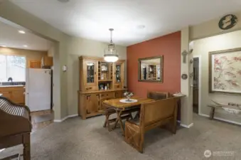 Formal dining room is adjacent to the kitchen.  Hallway leads to second bedroom, full bath and utility room.