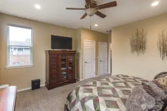 This view of the primary bedroom shows you the entry and side window that looks out to the back yard.