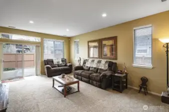 Another view of the living room showing the slider that leads to the back deck and access to the fenced yard.  There is no home directly behind this house, only the Lodge parking lot.