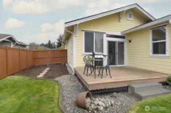 Deck off back slider is ready for outdoor dining or entertaining.   The extra wide side yard is unique to this community.  It receives lots of sun throughout the day, making it a perfect place for a garden.
