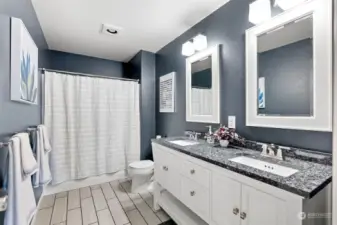 Newly upgraded guest bath with ceramic tile floors and dual vanity ensuring there is room for everyone.