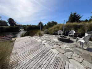 Wood walkway to the Dock, Stone Terrace and Firepit invite you back from your day on the water