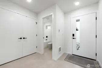 Another view of the entry and full bath. Model home, colors and finishes may vary.