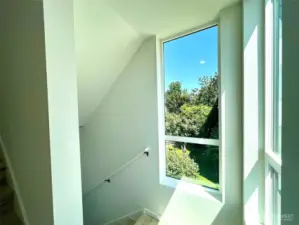 Upper level landing and verdant view.