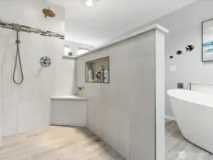 Stepping into an updatged shower with plenty of space is another added feature this home offers.