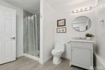 3/4 bathroom on lower level is perfect for guests to use while they are staying in the bonus room area or the family room. All updated with new flooring, tiled shower, new bathroom cabinet, light and mirrors!