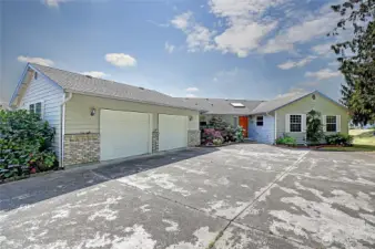 Large, paved driveway that takes you to main entrance and three car garage!