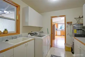 Oversized utility room with ample storage, utility sink, endless storage!