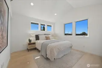Primary Suite with hardwoods and vaulted ceilings