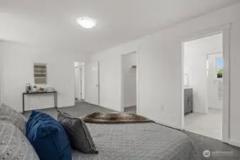 Upstairs, you’ll find a second spacious primary suite with its own private bath.