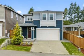 Modern two-story home with clean lines, attached garage, and welcoming curb appeal in a newer Auburn neighborhood.
