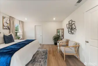 Alternate view of the primary bedroom highlighting space for seating or a workspace.