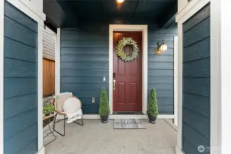 Covered front porch with welcoming entry and modern exterior details.