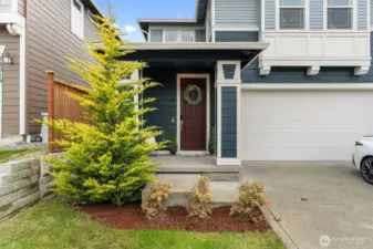 Front yard and entry view highlighting landscaping and curb appeal.