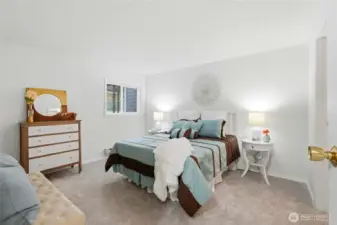 Spacious primary bedroom offers a peaceful retreat with plenty of room to unwind.