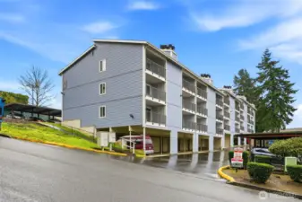 The rear of the building features an assigned covered parking space and a convenient private storage unit.