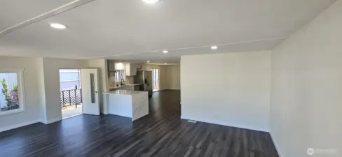 Living room looking East towards Kitchen and Dining room