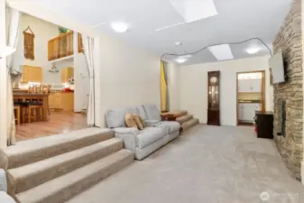 Living Room w/ cozy propane fireplace + bathroom / laundry room access