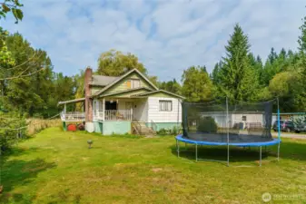 Frontal home view with shop and Manufactured home in the background