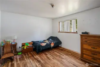 main floor bedroom with natural hardwood flooring