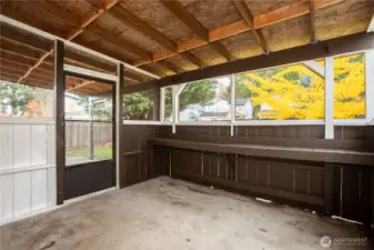 Covered porch with screen doors and screened in windows