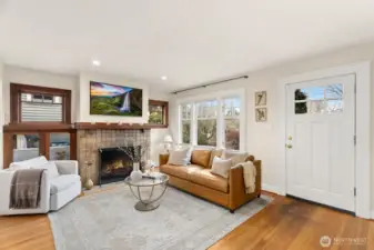 Very special Batchelder-tiled fireplace and original built-in cabinetry with glass doors, begging for books and art pieces.