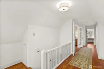 Upstairs landing opens to both a Primary bedroom and second bedroom.  Glowing fir floors throughout this level.