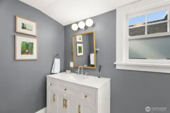 Sunny upper level full bath sports newer vanity able to house all of your personal necessities.