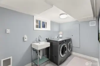 Lower level laundry room and sink is also connected to a large storage room for a Costco run, wine, suitcases, seasonal decor and sporting equipment!