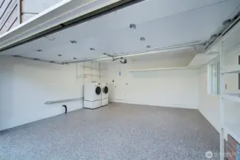 Newly polished garage with fresh paint and epoxy flooring. New garage door as well.