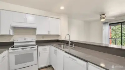 Another angle of this galley style kitchen showcases the flow as well as the light & bright feel.