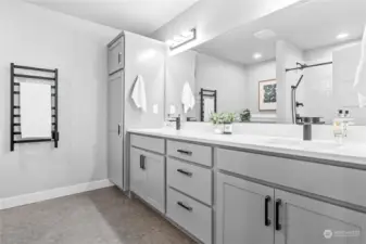 Primary bathroom with extra touches like towel warmer.