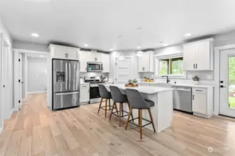 Updated kitchen with solid surface countertops and large pantry.