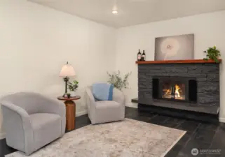 Second living room with custom wood burning fireplace and ceramic tile floors.