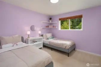 Bedroom 2 with custom shelves in closet.