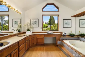 The primary bath has vaulted ceiling, duel sinks, makeup area, hardwood floors, tub & shower.