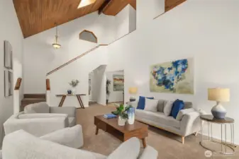 Living room looking back towards the front entry and open staircase.