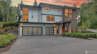 Nestled in a serene, forested enclave, this contemporary residence offers a striking yet tranquil retreat, where bold design meets thoughtful craftsmanship. Outside, enjoy a gorgeous, low-maintenance sanctuary with turf lawns, landscaped terraces and sprinkler system, all surrounded by lush forest. At dusk, landscape lighting illuminates the lush flora, creating a magical ambiance, frequently visited by a friendly family of deer.