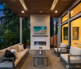 Outdoor covered living area with fireplace
