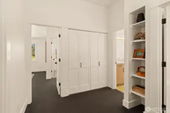 Built in shelving frames an open landing at the upstairs bedroom entrances. Utility laundry closet upstairs for convenient access.
