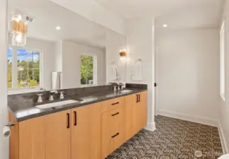 Double sinks with custom light sconces with heated floors.