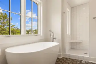 Separate soaking tub in spacious primary suite.